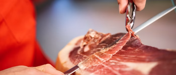 Butcher cutting raw meat