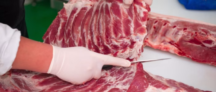 Butcher cutting ribs